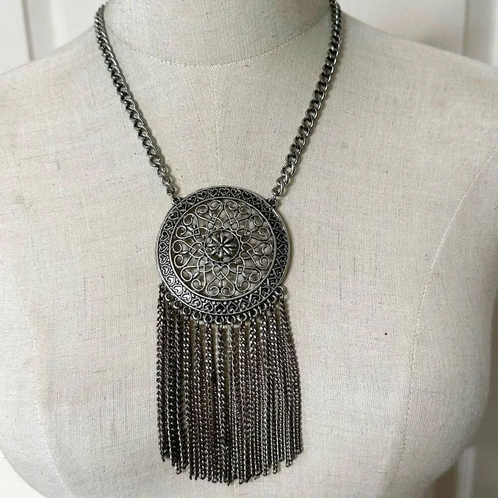 Silver tone medallion tassel statement necklace